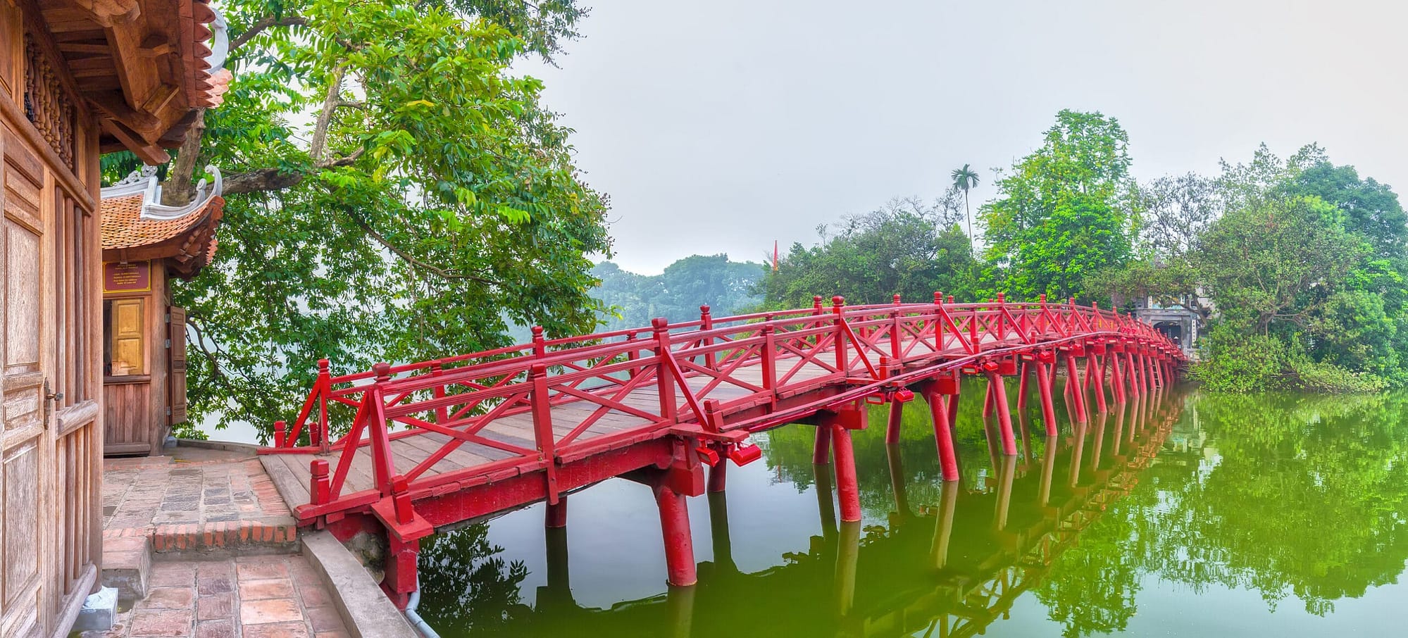 Huc Bridge spanning the Ngoc Son Temple, Hanoi, Vietnam with curved bridge architecture crawfish red symbolizes capital region thousands of years civilization, god temple tortoises enters Vietnam history